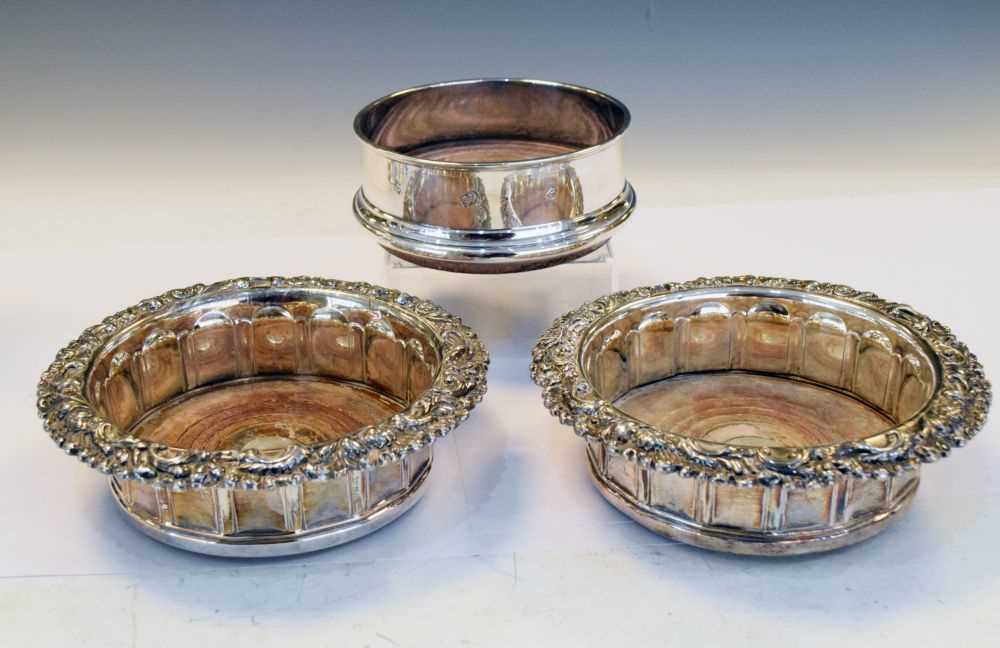 Lot 176 - Elizabeth II silver bottle coaster together with a pair of plated wine coasters