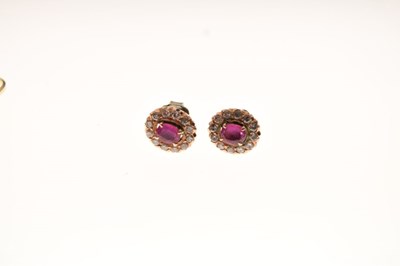 Lot 31 - Yellow metal, ruby, and diamond cluster ring, and matching earrings