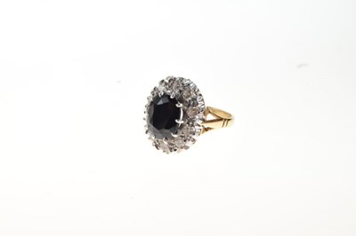 Lot 12 - Sapphire and diamond 18ct gold cluster ring