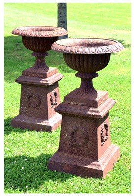 Lot 567 - Pair of Victorian cast iron garden urns on pedestal bases