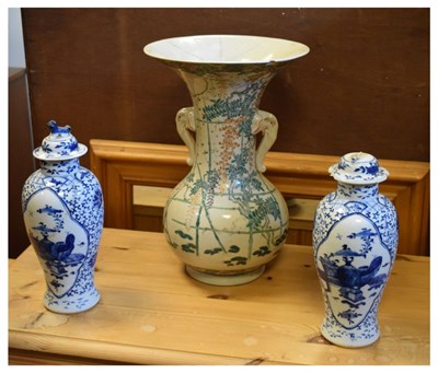 Lot 502 - Pair of blue and white jars and covers together with a vase