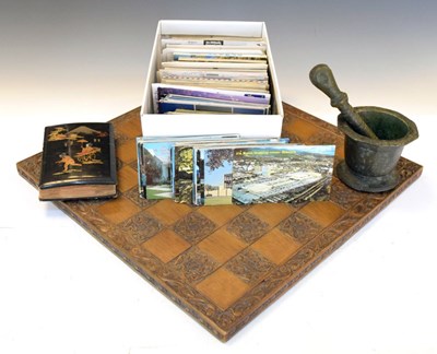 Lot 253 - Carved wooden chessboard, together with a  bronze pestle and mortar, postcards, etc