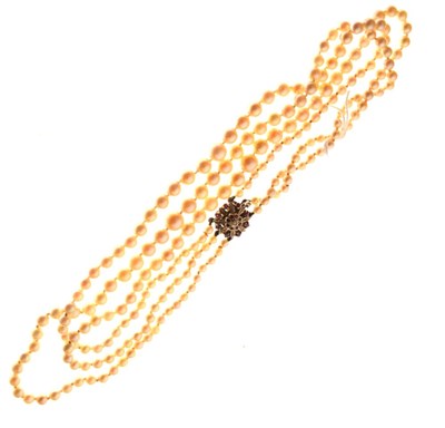 Lot 76 - Three-row graduated cultured pearl necklace to a diamond and ruby clasp