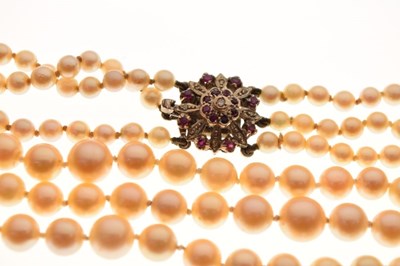 Lot 76 - Three-row graduated cultured pearl necklace to a diamond and ruby clasp