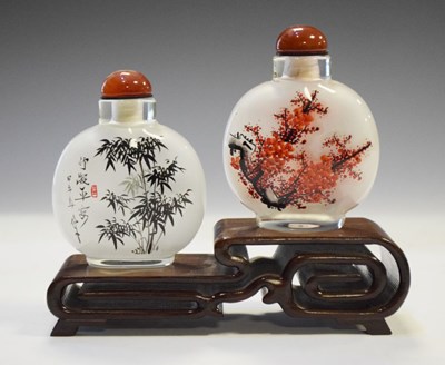 Lot 325 - Two Chinese interior painted glass snuff bottles on stand