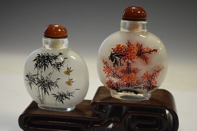 Lot 325 - Two Chinese interior painted glass snuff bottles on stand