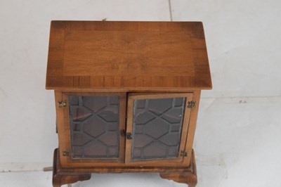 Lot 199 - Miniature walnut two-door cabinet on stand
