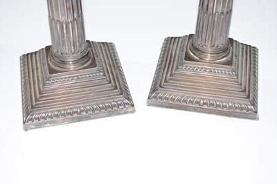 Lot 84 - Set of four Edward VII Corinthian column silver candlesticks