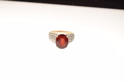 Lot 14 - 9ct gold ring set single faceted red stone and diamonds