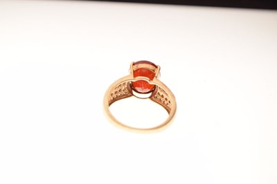 Lot 14 - 9ct gold ring set single faceted red stone and diamonds