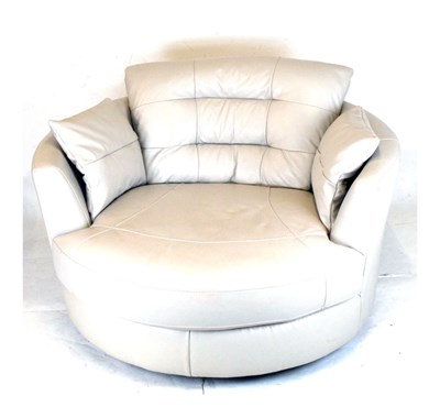 Lot 473 - Modern swivel circular snuggle sofa, upholstered in cream leatherette