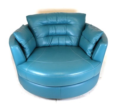 Lot 474 - Modern swivel circular snuggle sofa, upholstered in blue leatherette