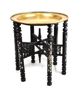 Lot 540 - Ebonised and inlaid brass top Benares style table