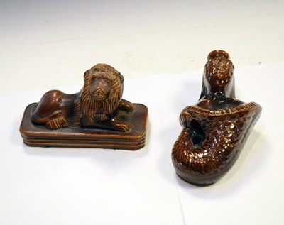 Lot 337 - 19th Century treacle-glazed pottery lion flask and mermaid flask (2)