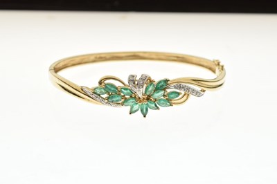 Lot 45 - 9k yellow metal, emerald and diamond snap bangle