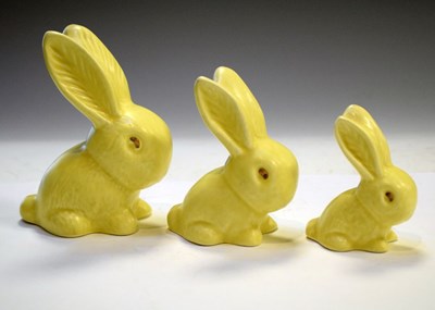 Lot 288 - Three graduated lemon yellow glaze rabbits largest marked 990