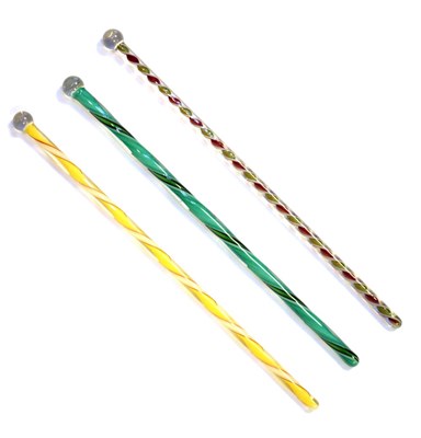 Lot 313 - Three Nailsea type coloured glass knitting needles