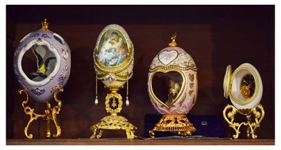 Lot 312 - Four House of Faberge collectors eggs to include Sweetheart Musical Carousel Egg, etc