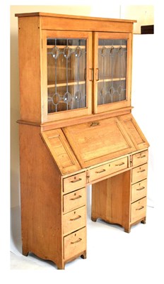 Lot 653 - Early 20th Century light oak bureau bookcase