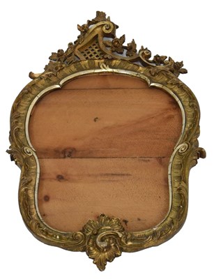 Lot 556 - Rococo style giltwood framed cartouche shaped mirror