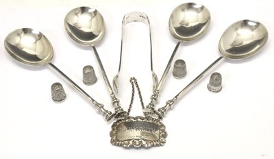 Lot 154 - Four Edward VII silver spoons, three silver thimbles, Victorian sugar tongs and a decanter label