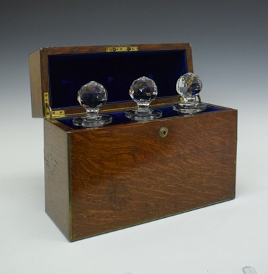 Lot 197 - Late Victorian or Edwardian brass-bound oak-cased three bottle decanter box