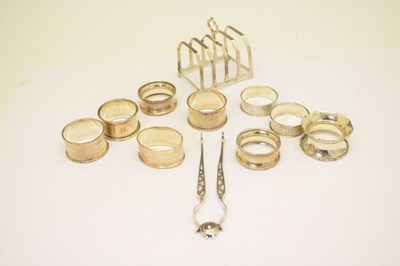 Lot 131 - Group of assorted silver napkin rings, a pair of Georgian sugar tongs and a George VI toast rack