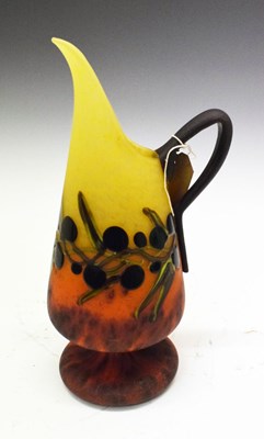 Lot 274 - Art glass ewer, of pedestal form decorated with trailing leaf and berry decoration