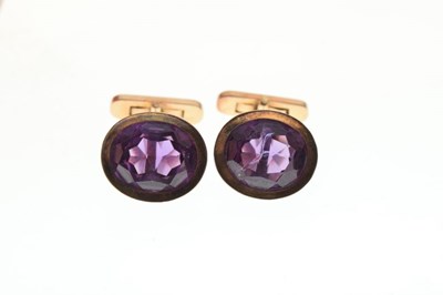 Lot 60 - Pair of gold cufflinks with amethyst coloured stones