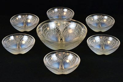 Lot 280 - Rene Lalique 'Coquilles' opalescent glass set of one large and six small bowls