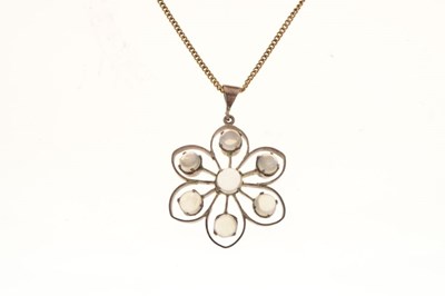 Lot 65 - White metal floral design pendant set seven moonstones, on a silver gilt chain