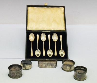 Lot 166 - Cased set of six George V silver pattern teaspoons, together with six silver napkin rings