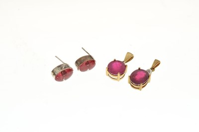 Lot 52 - Two similar pendants  set rubies and white stones, and a pair of white metal stud earrings