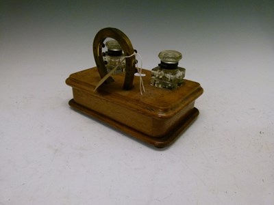 Lot 560 - Late Victorian oak desk stand with brass horseshoe design pen stand