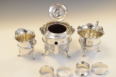 Lot 148 - Edwardian VII silver three-piece tea set and three silver napkin rings