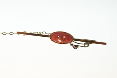 Lot 73 - Guilloche blue enamel and seed pearl decorated bar brooch, and a cinnabar bar brooch