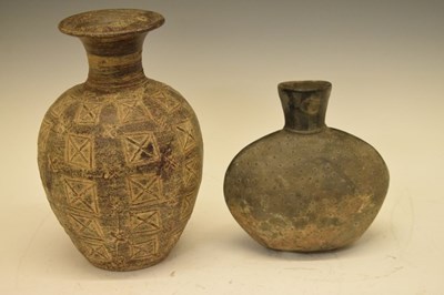 Lot 167 - Elliptical pottery vase with raised surface decoration and black finish