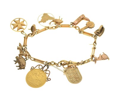 Lot 55 - 18ct gold bracelet attached various charms, and a George V half sovereign