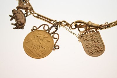 Lot 55 - 18ct gold bracelet attached various charms, and a George V half sovereign