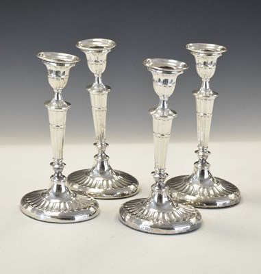 Lot 190 - Set of four Edwardian silver Adams style candlesticks of oval form
