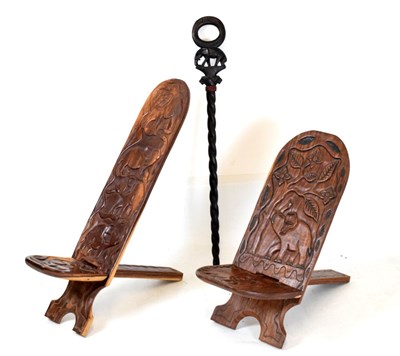 Lot 668 - Two African carved hardwood folding stools and a staff