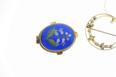 Lot 31 - Crescent shaped brooch set seed pearls, stamped '15ct', a yellow metal target brooch, and a floral decorated brooch (3)