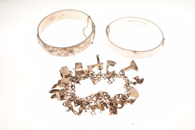 Lot 64 - Two silver snap bangles, and a silver charm bracelet