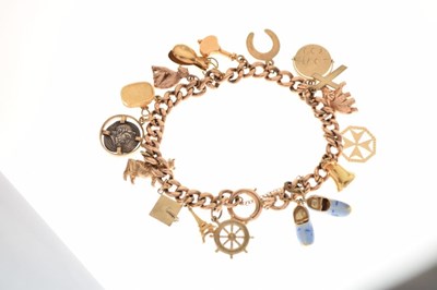 Lot 53 - 9ct gold curb link bracelet, attached various charms