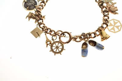 Lot 53 - 9ct gold curb link bracelet, attached various charms