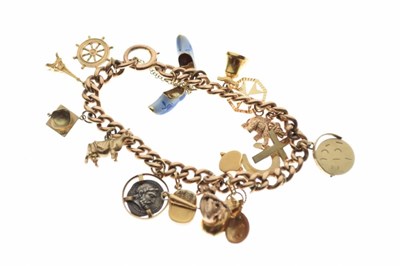 Lot 53 - 9ct gold curb link bracelet, attached various charms
