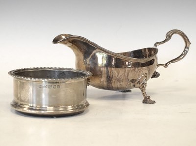 Lot 137 - Elizabeth II silver sauceboat plus a silver-mounted bottle coaster