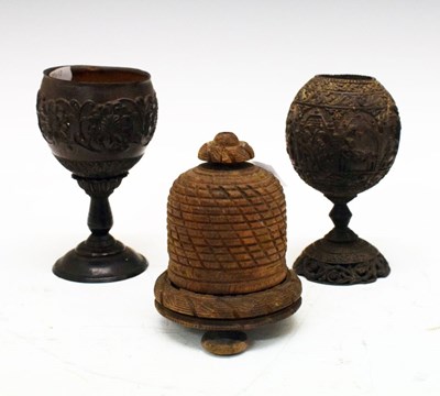 Lot 214 - Two carved coconut cups together with a string box in the form of a beehive