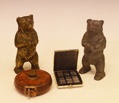 Lot 185 - Two cast moneyboxes, cased travel dominoes, leather tape measure