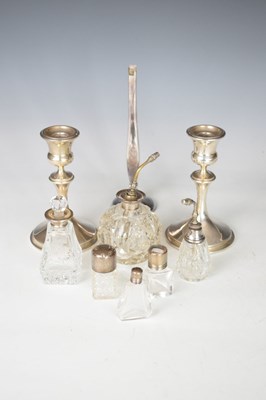 Lot 148 - Quantity of silver to include; bud vase, candlesticks and bottles